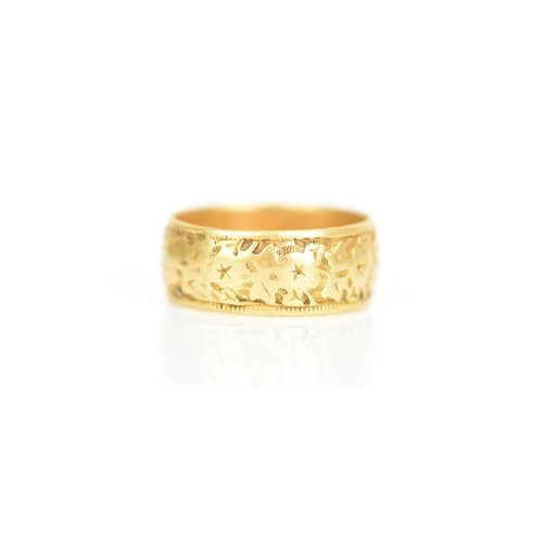 240 - An 18ct yellow gold wedding band, engraved with a floral design, ring size P 1/2, 7.4 grams
If there... 