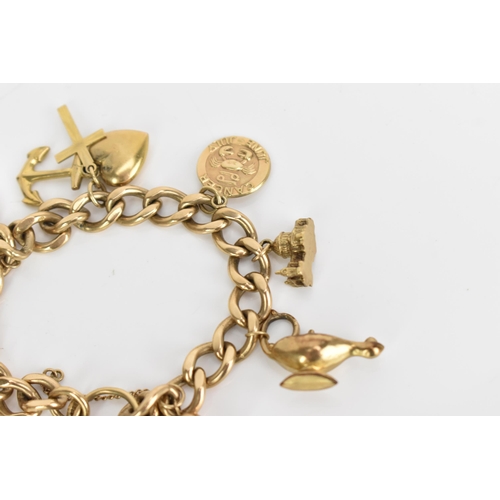 241 - A 9ct gold curb link charm bracelet, with various 9ct gold and yellow metal charms including a candl... 