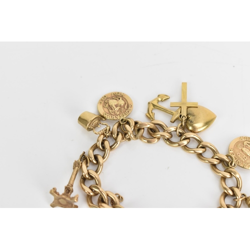 241 - A 9ct gold curb link charm bracelet, with various 9ct gold and yellow metal charms including a candl... 