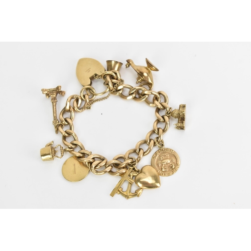 241 - A 9ct gold curb link charm bracelet, with various 9ct gold and yellow metal charms including a candl... 