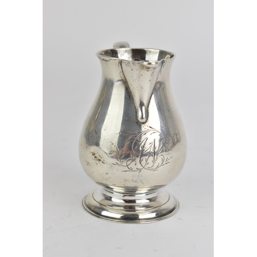 29 - A George II silver sparrow beak cream jug, by Elizabeth Goodwin, hallmarked London 1730, having a sc... 