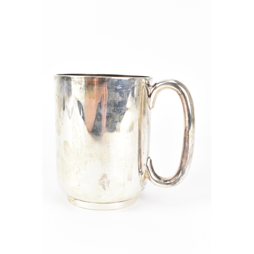 3 - An Edwardian silver mug, by Atkin Brothers, hallmarked Sheffield 1907, having a C-shaped handle and ... 