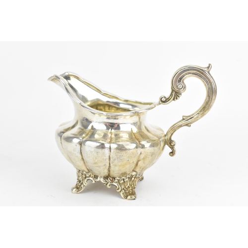 33 - A Victorian silver jug, makers marks 'WS', hallmarked London 1838, having a scroll shaped handle, cr... 