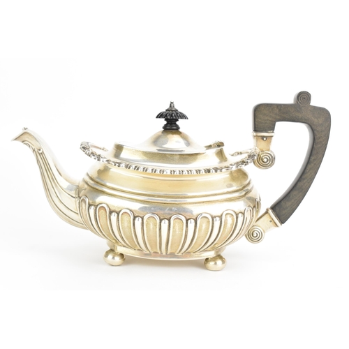 4 - An Edwardian silver teapot, by Joseph Rodgers & Sons, hallmarked Sheffield 1906, having an ebonised ... 