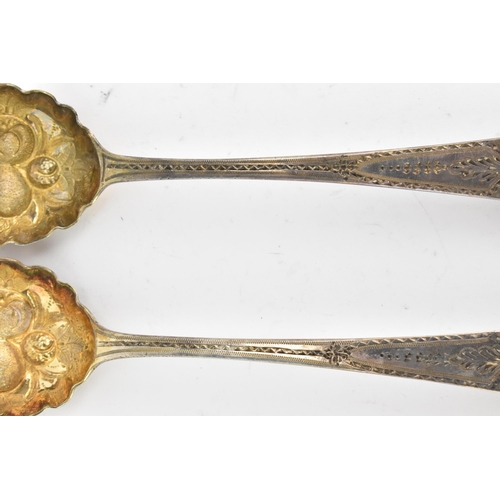 40 - Two George III silver berry spoons hallmarked London 1788, having fruit embossed bowls and bright-cu... 