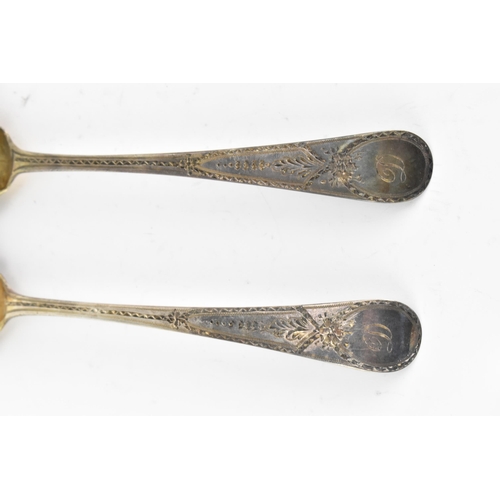 40 - Two George III silver berry spoons hallmarked London 1788, having fruit embossed bowls and bright-cu... 