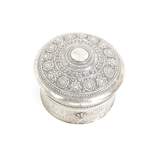 44 - An early 20th century Indian white metal betel box, of circular form, embossed and incised with repe... 