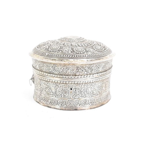 44 - An early 20th century Indian white metal betel box, of circular form, embossed and incised with repe... 