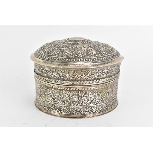 44 - An early 20th century Indian white metal betel box, of circular form, embossed and incised with repe... 