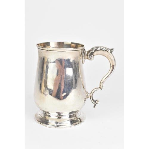 5 - A George III silver christening mug, makers marks rubbed, hallmarked London 1773, of baluster form w... 