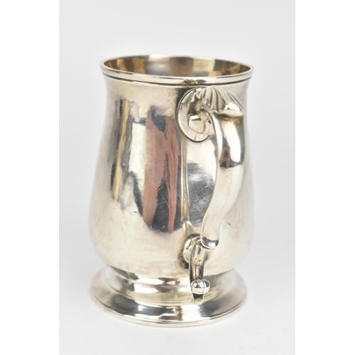 5 - A George III silver christening mug, makers marks rubbed, hallmarked London 1773, of baluster form w... 