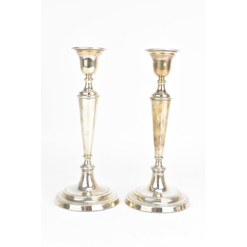 50 - A pair of Elizabeth II silver candlesticks, by W.E.Vokes, hallmarked London 1991, each with weighted... 