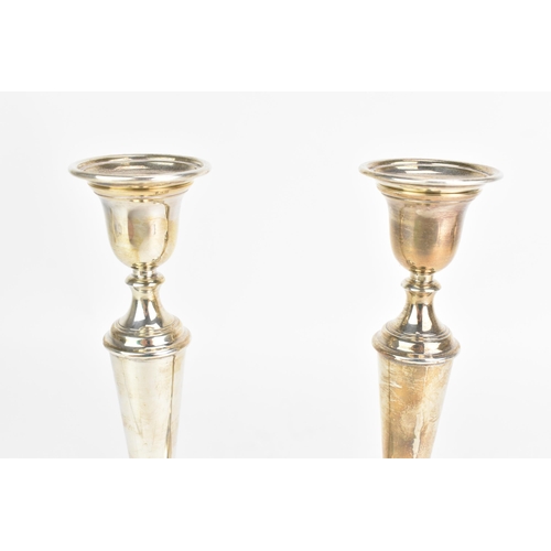 50 - A pair of Elizabeth II silver candlesticks, by W.E.Vokes, hallmarked London 1991, each with weighted... 