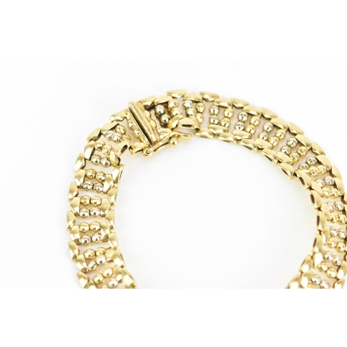 52 - An 18ct yellow gold bracelet, having a repeating ball design and an open box clasp, stamped 750, 18.... 