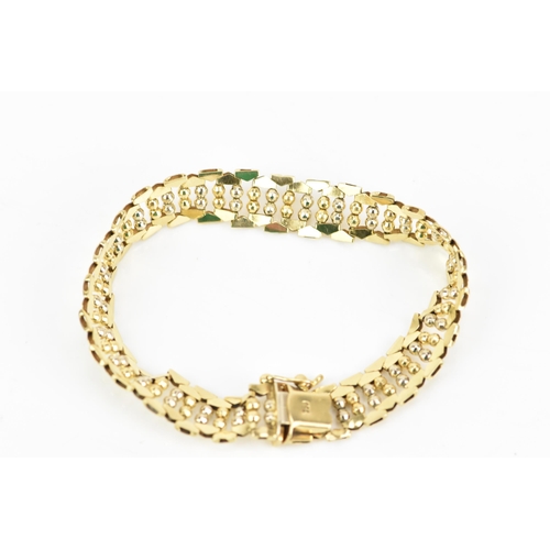 52 - An 18ct yellow gold bracelet, having a repeating ball design and an open box clasp, stamped 750, 18.... 