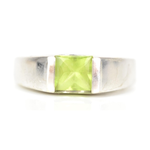 62 - A 14ct white gold and peridot dress ring, the peridot 5.3mm x 5.3mm, ring size M, 5.5 grams
If there... 