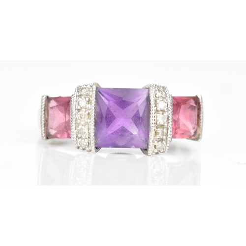 63 - A 14ct white gold amethyst and pink tourmaline dress ring, the cushion square cut amethyst 6.8mm wit... 