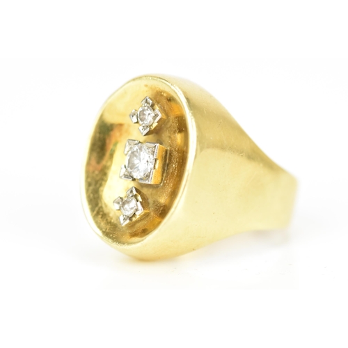 65 - A yellow gold and three stone diamond dress ring, the central diamond 3.2mm diameter flanked by two ... 