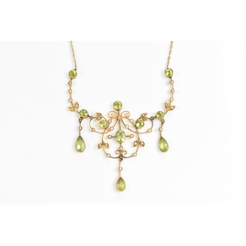 66 - An Edwardian 9ct gold necklace, set with eleven faceted cut peridots and thirty-three seed pearls, t... 