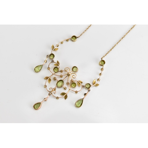 66 - An Edwardian 9ct gold necklace, set with eleven faceted cut peridots and thirty-three seed pearls, t... 