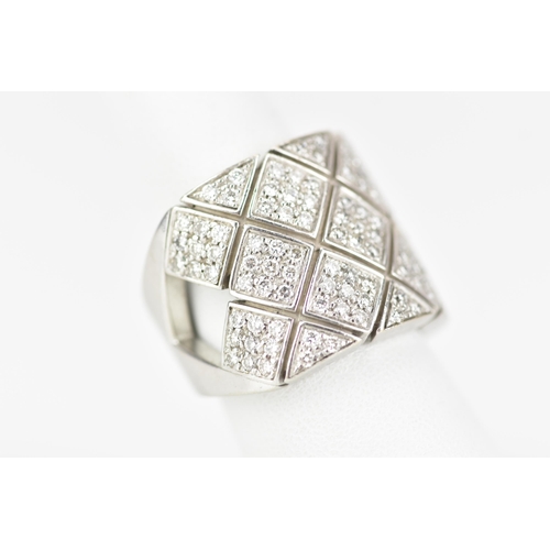 67 - A white gold diamond dress ring, tests at 18ct, set with approximately 117 diamonds with lozenges an... 