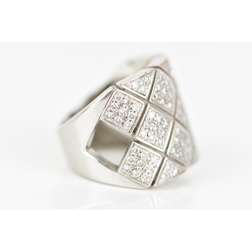 67 - A white gold diamond dress ring, tests at 18ct, set with approximately 117 diamonds with lozenges an... 