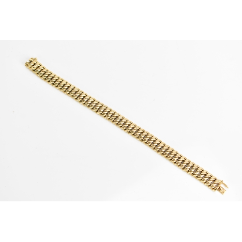 69 - A yellow gold chain link bracelet, tests at 18ct gold, having an open box clasp and with an interloc... 