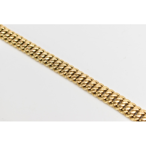 69 - A yellow gold chain link bracelet, tests at 18ct gold, having an open box clasp and with an interloc... 