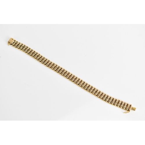 69 - A yellow gold chain link bracelet, tests at 18ct gold, having an open box clasp and with an interloc... 