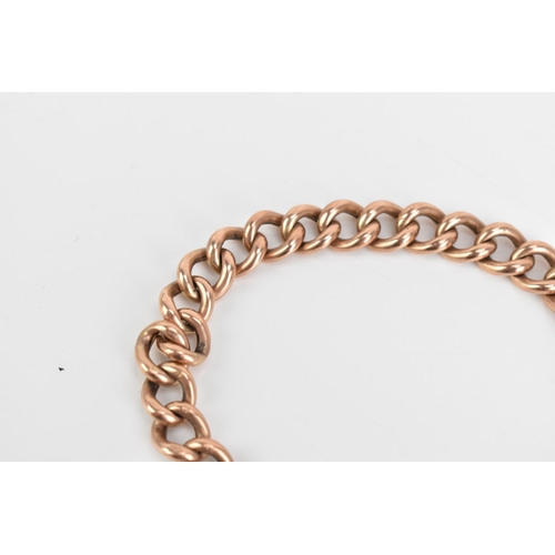 71 - A 9ct rose gold curb link chain bracelet, having a heart shaped padlock clasp and safety chain, stam... 