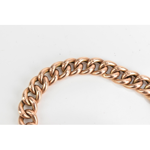 74 - A 9ct rose gold curb link chain bracelet, having a heart shaped padlock clasp and safety chain, appr... 