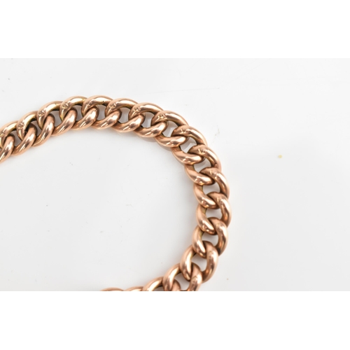 74 - A 9ct rose gold curb link chain bracelet, having a heart shaped padlock clasp and safety chain, appr... 