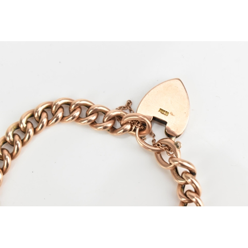 74 - A 9ct rose gold curb link chain bracelet, having a heart shaped padlock clasp and safety chain, appr... 