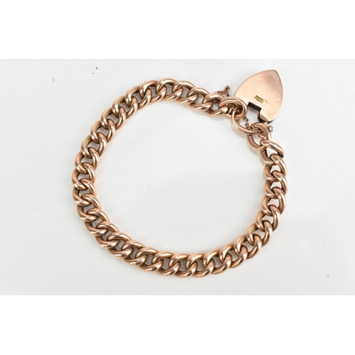 74 - A 9ct rose gold curb link chain bracelet, having a heart shaped padlock clasp and safety chain, appr... 