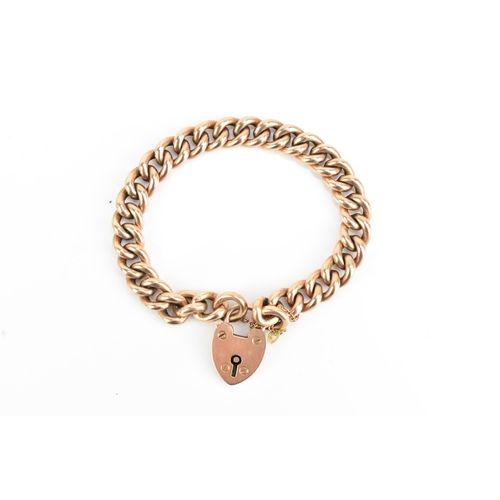 75 - A 9ct rose gold curb link chain bracelet, having a heart shaped padlock clasp and safety chain, appr... 