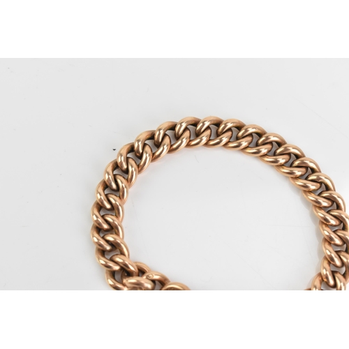 75 - A 9ct rose gold curb link chain bracelet, having a heart shaped padlock clasp and safety chain, appr... 