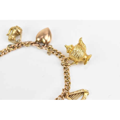 77 - A 9ct rose gold curb link charm bracelet, with various 9ct gold and yellow metal charms including a ... 