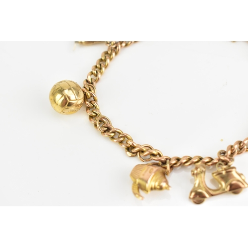 77 - A 9ct rose gold curb link charm bracelet, with various 9ct gold and yellow metal charms including a ... 