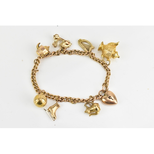 77 - A 9ct rose gold curb link charm bracelet, with various 9ct gold and yellow metal charms including a ... 