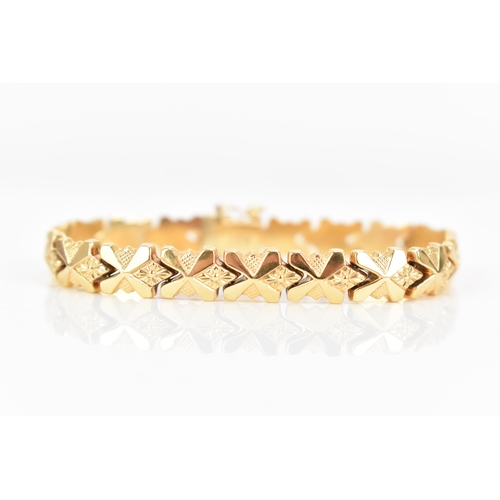 85 - An Italian UnoAerre 18ct gold fancy link bracelet, with an open box clasp, stamped 750, 18cm, 13.1 g... 