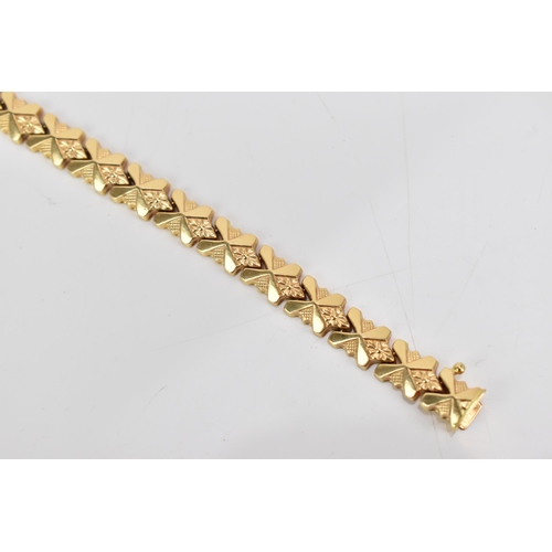 85 - An Italian UnoAerre 18ct gold fancy link bracelet, with an open box clasp, stamped 750, 18cm, 13.1 g... 