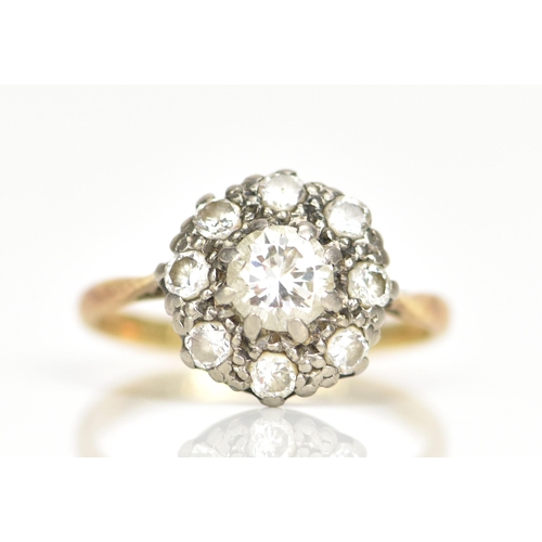 97 - An 18ct gold and platinum diamond daisy cluster engagement ring, the central brilliant cut diamond i... 