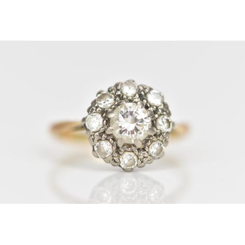 97 - An 18ct gold and platinum diamond daisy cluster engagement ring, the central brilliant cut diamond i... 