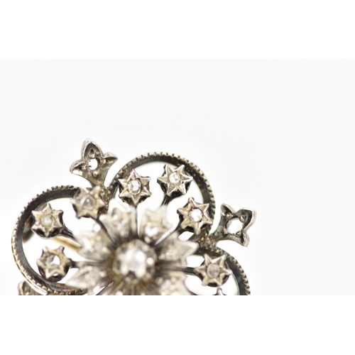 98 - A Victorian gold and white metal diamond floral brooch, the flowerhead en tremblant with central dia... 