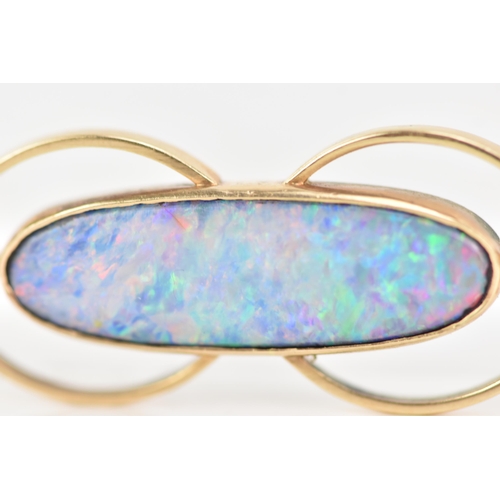 243 - A 9ct yellow gold and opal brooch, the oval opal 25.8mm x 7.7mm set in a pierced frame, stamped 9ct,... 