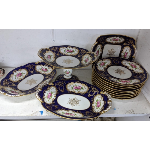 125 - An early 20th century Coalport porcelain, hand painted dessert service, on a cobalt blue ground and ... 