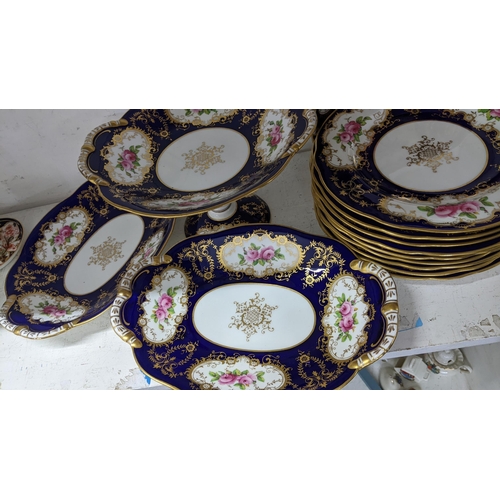 125 - An early 20th century Coalport porcelain, hand painted dessert service, on a cobalt blue ground and ... 