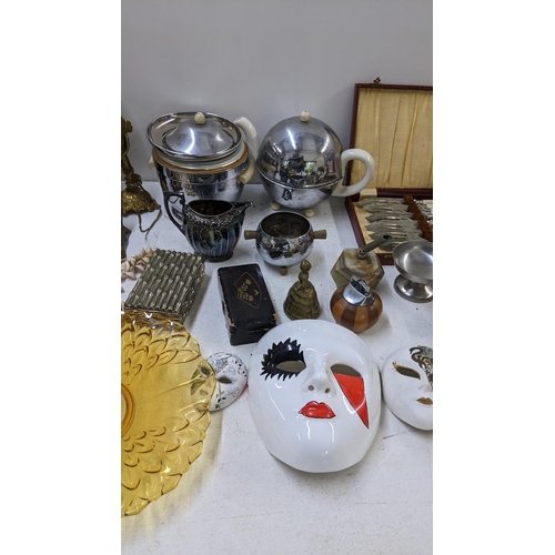 130 - A mixed lot to include a silver plated teaset, onyx table lighter, treen carved animals and other it... 