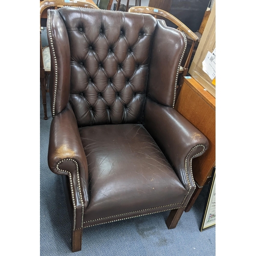 237 - A mid 20th century brown leather, button back upholstered, wingback armchair
Location: A2M
If there ... 