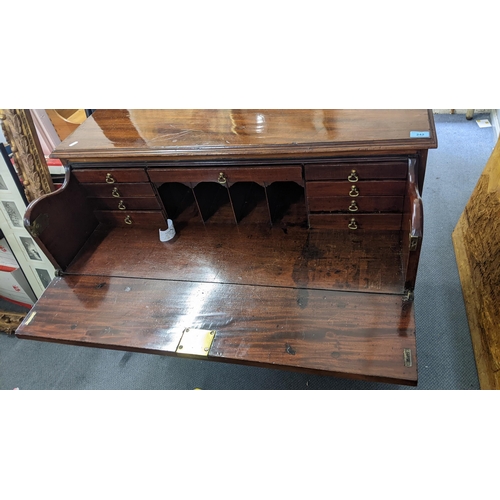 242 - An early 19th century mahogany secretaire chest having a fitted interior above three drawers on brac... 